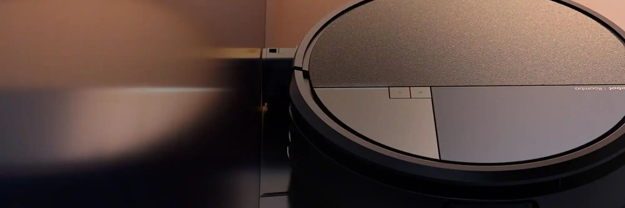 A new Roomba&reg; robot on a reflective floor at sunset