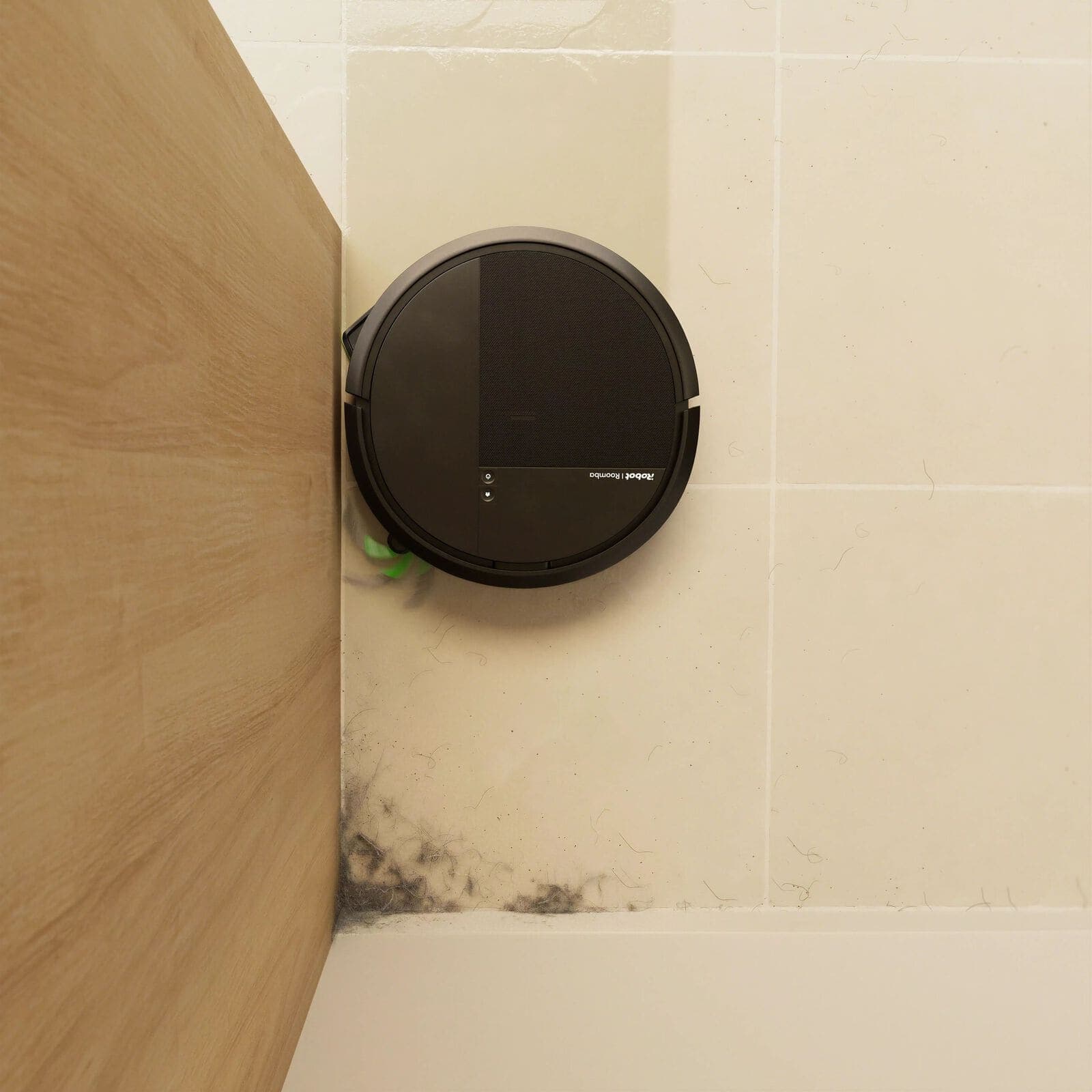 Roomba&reg; 115 Combo robot extending its edge-sweeping brush to reach dust in a bathroom corner