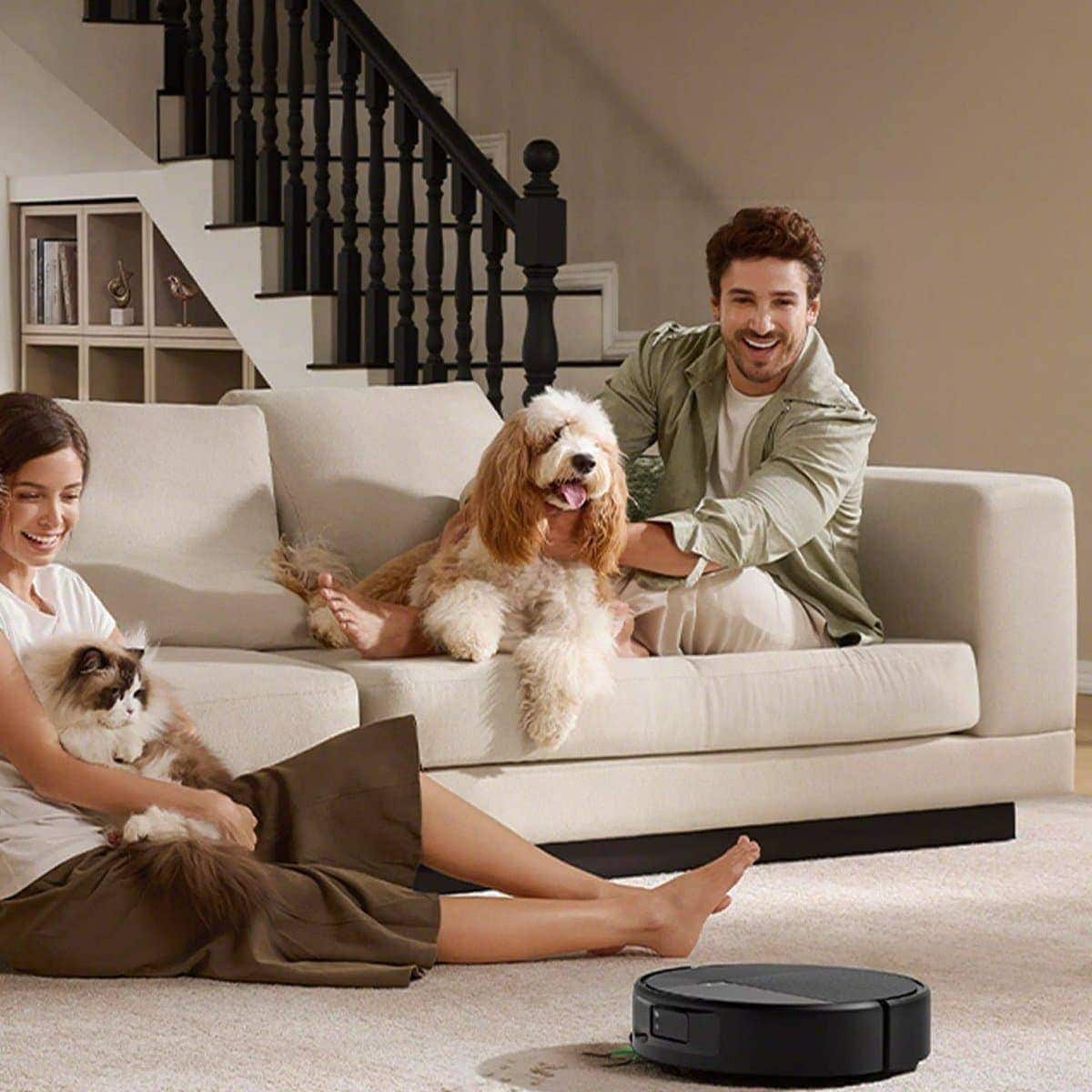Roomba&reg; Max 875 Combo robot vacuuming a carpet while a family and their pets sit on the sofa
