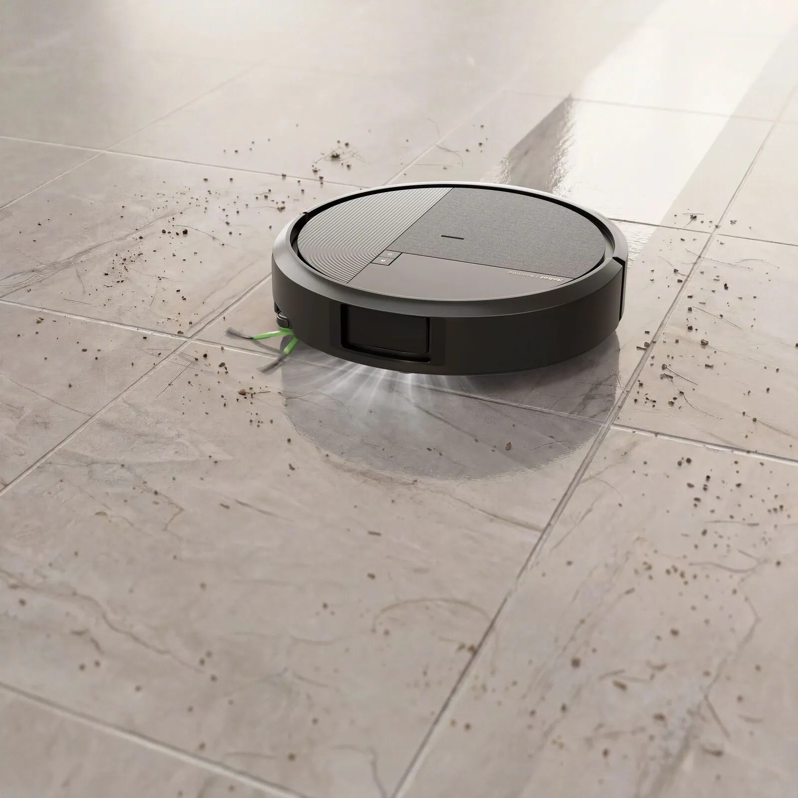 Roomba&reg; Plus 575 Combo robot picking up dust and hair from a tiled floor